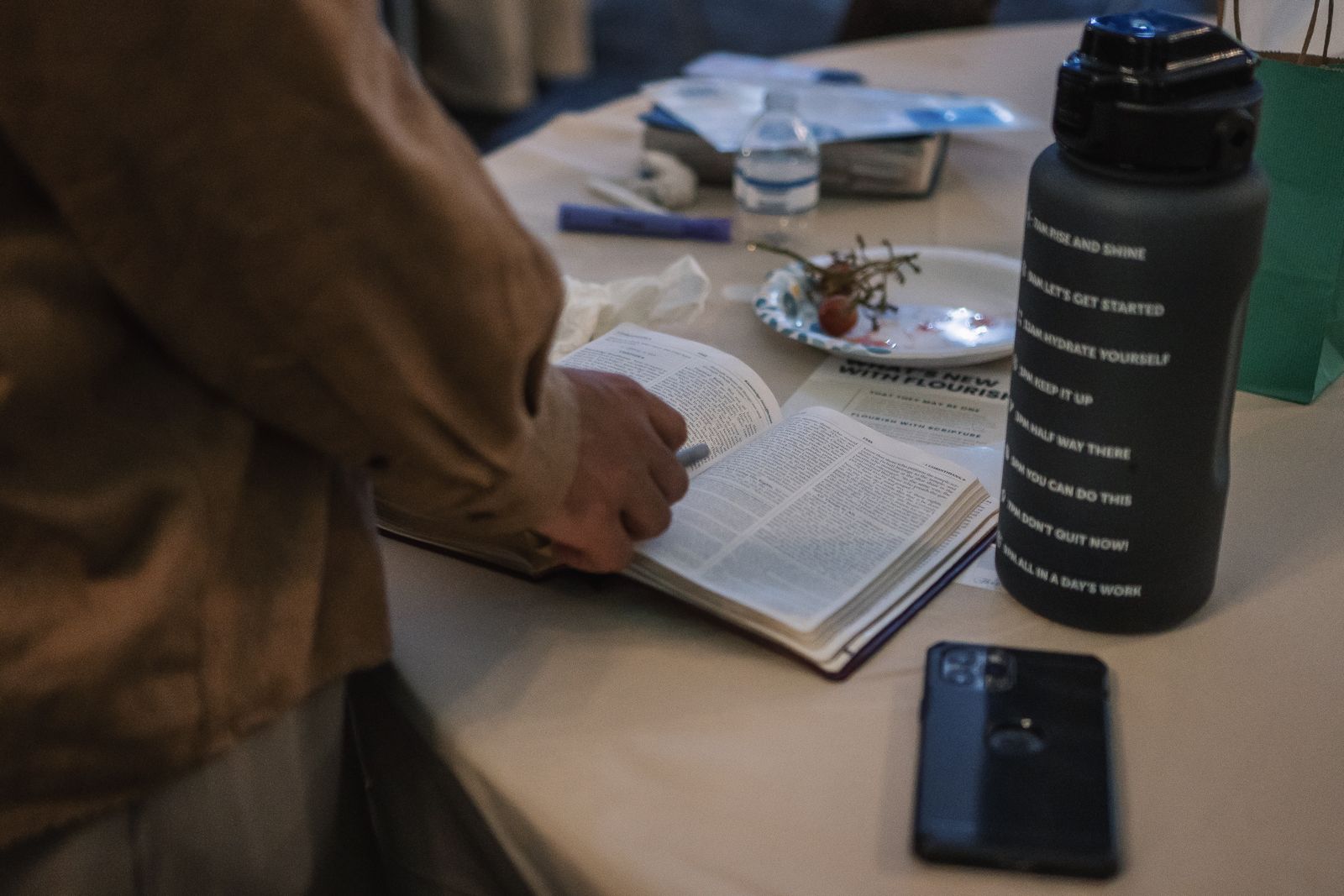 Hands resting on an open Bible
